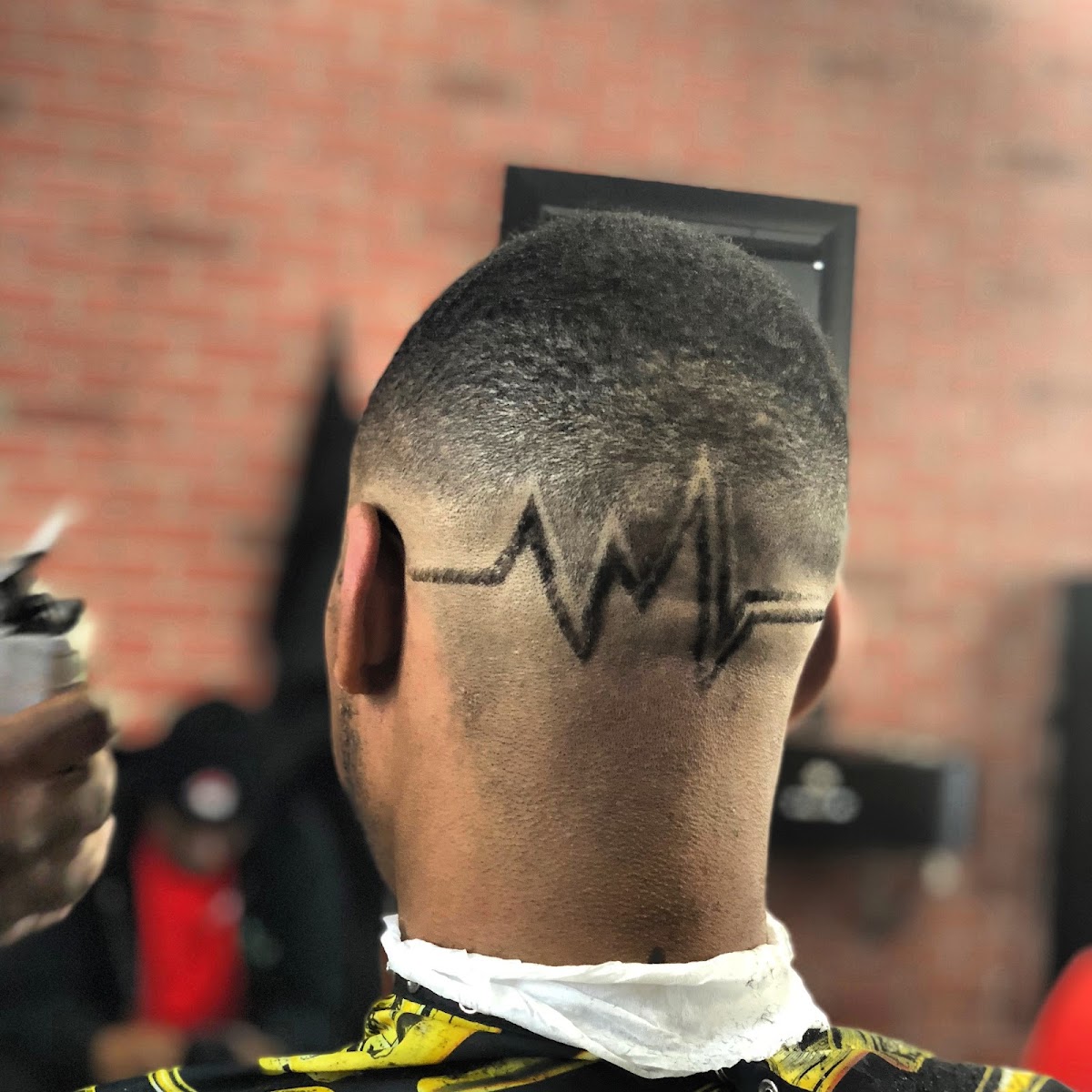 Custom hair design freehanded into a fresh fade