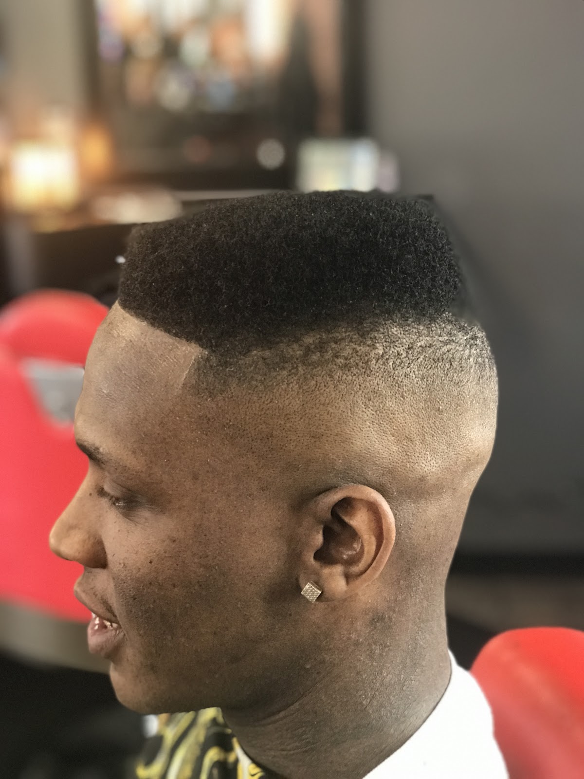 Box-style cut with a clean skin fade and sharp edge-up, side profile